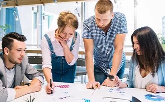 Two men and 2 women working together