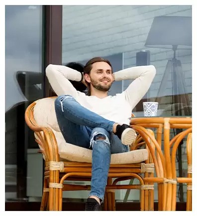 a guy chilling on a chair