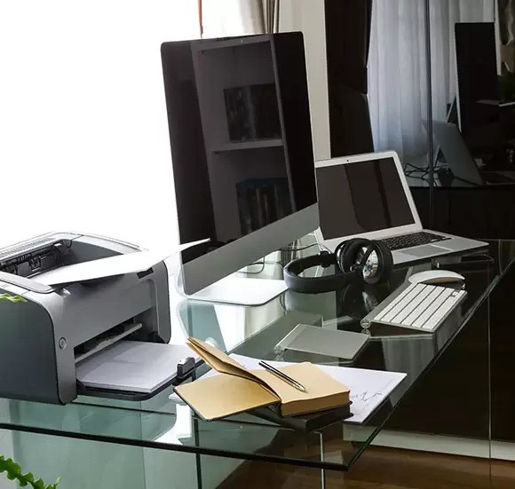 a laptop, monitor on a table