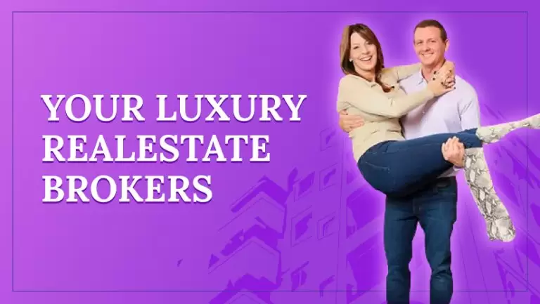 A man holding a woman in his hands for a pose, representing a real estate brokers company